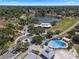 Aerial view of a splash pad, nearby lake, and a modern building in a community park at 378 W Osceola St, Clermont, FL 34711