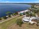 An aerial view featuring a nearby beach, lake, a modern building, and a splashpad at 378 W Osceola St, Clermont, FL 34711