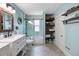 Bright bathroom featuring white cabinets, a glass-enclosed shower, and decorative shelving at 378 W Osceola St, Clermont, FL 34711