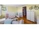 Cozy Bedroom room featuring hardwood floors, two cribs, and a rocking chair at 378 W Osceola St, Clermont, FL 34711