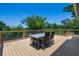 Outdoor deck area with wood flooring, a dining table, and lake views at 378 W Osceola St, Clermont, FL 34711