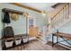 Welcoming entryway featuring a coat rack with bench, stairwell, and hardwood flooring at 378 W Osceola St, Clermont, FL 34711