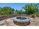 Outdoor fire pit area surrounded by landscaping and greenery at 378 W Osceola St, Clermont, FL 34711