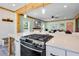 Stylish kitchen featuring a cooktop island, bright windows, and open layout to the living area at 378 W Osceola St, Clermont, FL 34711