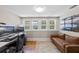 Bright home office with multiple monitors, hardwood floors, and comfortable sofa at 378 W Osceola St, Clermont, FL 34711