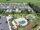 Aerial view showcases community amenities, including a pool, recreation area, and bocce ball courts at 3817 Miragalia Ln, The Villages, FL 32163