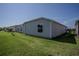 The lush green backyard includes a view of neighboring houses at 3817 Miragalia Ln, The Villages, FL 32163