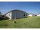 A wide, green backyard with ample lawn space and views of neighboring houses at 3817 Miragalia Ln, The Villages, FL 32163