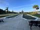 Bocce ball courts with manicured landscaping and benches, surrounded by a peaceful community setting at 3817 Miragalia Ln, The Villages, FL 32163