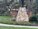 Welcoming entrance sign for Fenney Recreation Center and Grill, surrounded by colorful flowers and lush greenery at 3817 Miragalia Ln, The Villages, FL 32163