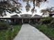 Inviting exterior of the Fenney Recreation Center with covered porch, manicured landscaping, and welcoming walkway at 3817 Miragalia Ln, The Villages, FL 32163