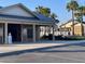 Exterior view of the recreation center and postal center, with palm trees and clear blue skies at 3817 Miragalia Ln, The Villages, FL 32163