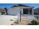 Charming home featuring a two-car garage, inviting screened porch, and well-maintained front yard at 3817 Miragalia Ln, The Villages, FL 32163