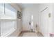 Bright front foyer featuring tile flooring, decorative glass, and ample closet space at 3817 Miragalia Ln, The Villages, FL 32163