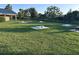 Well-maintained horseshoe pits on a green lawn, providing an opportunity for outdoor recreation at 3817 Miragalia Ln, The Villages, FL 32163