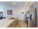 Bright kitchen features recessed lighting, stainless appliances and a convenient breakfast bar at 3817 Miragalia Ln, The Villages, FL 32163