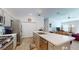 Spacious kitchen with stainless appliances, central island with breakfast bar, and recessed lighting at 3817 Miragalia Ln, The Villages, FL 32163