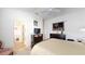 Cozy main bedroom featuring a comfortable bed, TV, and an en-suite bathroom at 3817 Miragalia Ln, The Villages, FL 32163