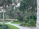 Picturesque nature trail with a wooden bridge, lush greenery, and serene pathways under moss-draped trees at 3817 Miragalia Ln, The Villages, FL 32163