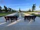 Outdoor shuffleboard court with seating area, offering a fun recreational activity in the community at 3817 Miragalia Ln, The Villages, FL 32163