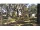 Large backyard featuring mature trees, a wooden fence, and a glimpse of the house at 3930 Griffin Ave, Lady Lake, FL 32159