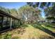 Expansive backyard showcasing mature trees, grassy areas, and additional structures at 3930 Griffin Ave, Lady Lake, FL 32159