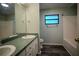 Bathroom featuring double sinks, a vanity with storage, and a tub with a new paint job at 3930 Griffin Ave, Lady Lake, FL 32159