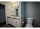 Bathroom featuring double sinks, a vanity with storage, and a toilet with a new paint job at 3930 Griffin Ave, Lady Lake, FL 32159
