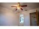 Bright bedroom featuring a ceiling fan, neutral carpet, and closet, offering a comfortable and inviting space at 3930 Griffin Ave, Lady Lake, FL 32159