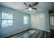 Bedroom with new floors, ceiling fan, closet, and two windows providing natural light and nice views at 3930 Griffin Ave, Lady Lake, FL 32159