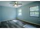 Bedroom with new floors, ceiling fan, and two windows providing ample natural light and nice views at 3930 Griffin Ave, Lady Lake, FL 32159