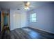 Bedroom with new floors, ceiling fan, closet, and one window providing natural light and nice views at 3930 Griffin Ave, Lady Lake, FL 32159