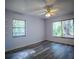 Bedroom with new floors, ceiling fan, and two large windows providing ample natural light and nice views at 3930 Griffin Ave, Lady Lake, FL 32159