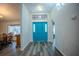 Inviting entryway with stylish wood-style flooring and a striking blue front door at 3930 Griffin Ave, Lady Lake, FL 32159