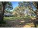 Sprawling estate featuring lush greenery and multiple buildings nestled amongst mature trees at 3930 Griffin Ave, Lady Lake, FL 32159