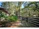 Landscaped exterior of a home, featuring a wooden fence line with mature plants in the yard at 3930 Griffin Ave, Lady Lake, FL 32159