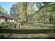 Exterior shot of a home featuring a wood fence line bordering the expansive yard and wooded area at 3930 Griffin Ave, Lady Lake, FL 32159