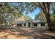 Well-maintained one-story home with mature trees, a shed, and a long driveway at 3930 Griffin Ave, Lady Lake, FL 32159