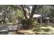 Exterior front view of property with mature trees and landscaping at 3930 Griffin Ave, Lady Lake, FL 32159