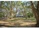Exterior front view of property with mature trees and landscaping and well manicured lawn at 3930 Griffin Ave, Lady Lake, FL 32159