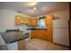 Kitchen with tile floors, stainless steel sink, white appliances, and light wood cabinets at 3930 Griffin Ave, Lady Lake, FL 32159