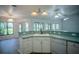 Bright kitchen features ample counter space, under cabinet lighting, and a view to the backyard at 3930 Griffin Ave, Lady Lake, FL 32159