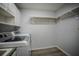 Utility room showing front load washer and dryer set with storage and hanging rack at 3930 Griffin Ave, Lady Lake, FL 32159