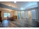 Spacious living room and dining room with elegant columns and wood-style flooring at 3930 Griffin Ave, Lady Lake, FL 32159