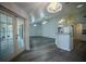 Light-filled living room has wood-look floors, white trim, neutral paint and french doors to outdoor space at 3930 Griffin Ave, Lady Lake, FL 32159