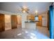 Open-concept living area with carpet, open to the kitchen with sleek countertops at 3930 Griffin Ave, Lady Lake, FL 32159