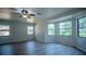 Large open living room with new floors, ceiling fan, and big windows providing ample natural light and nice views at 3930 Griffin Ave, Lady Lake, FL 32159
