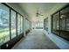 Spacious enclosed patio with ceiling fans and large windows providing natural light and scenic views of the property at 3930 Griffin Ave, Lady Lake, FL 32159