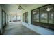 Spacious enclosed patio with ceiling fans and large windows providing natural light and scenic views of the property at 3930 Griffin Ave, Lady Lake, FL 32159