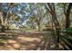 Lush, private property with multiple outbuildings amid a canopy of mature trees and fenced pasture land at 3930 Griffin Ave, Lady Lake, FL 32159